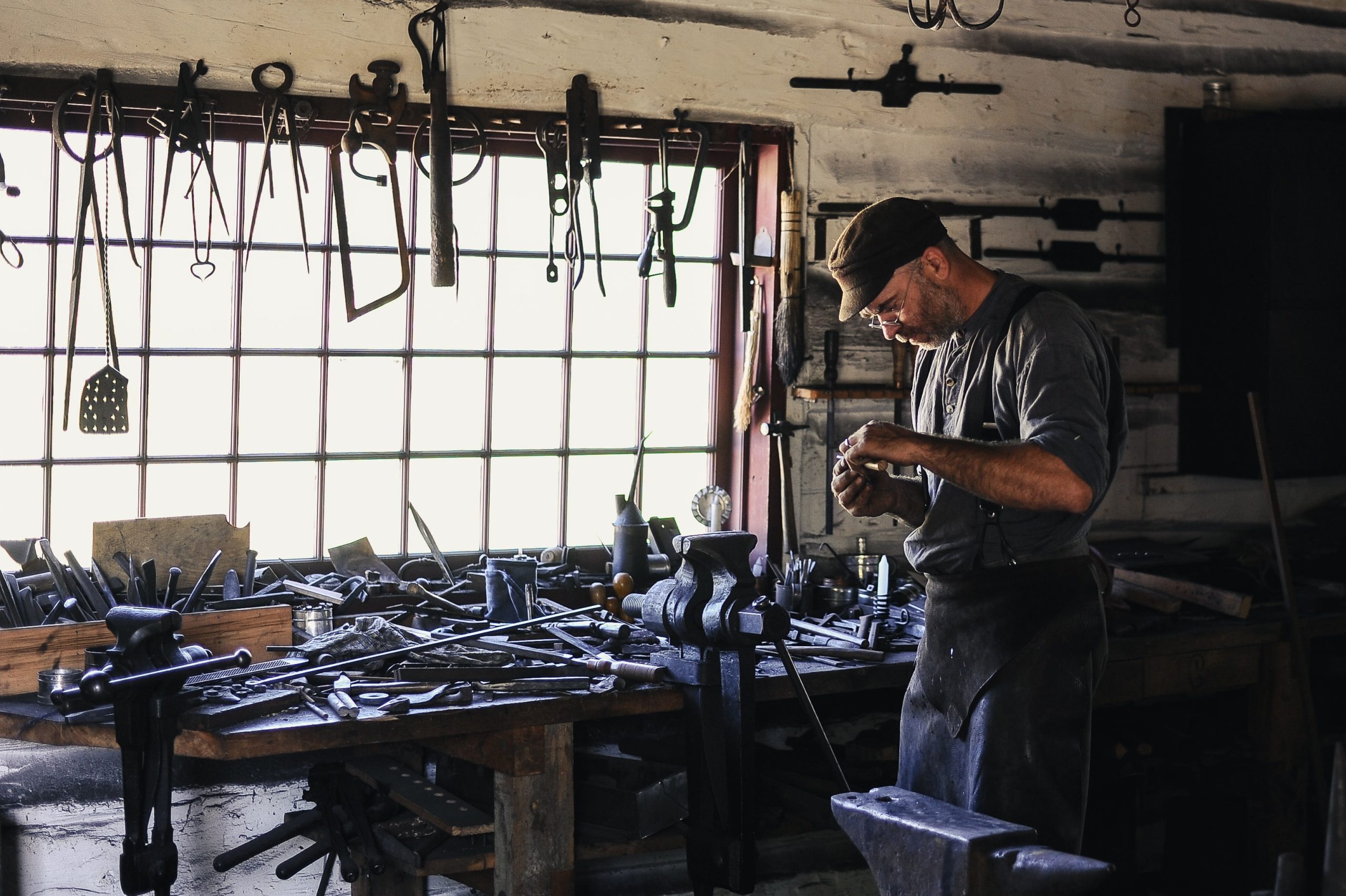 Tradesman looking at tools in his shed.