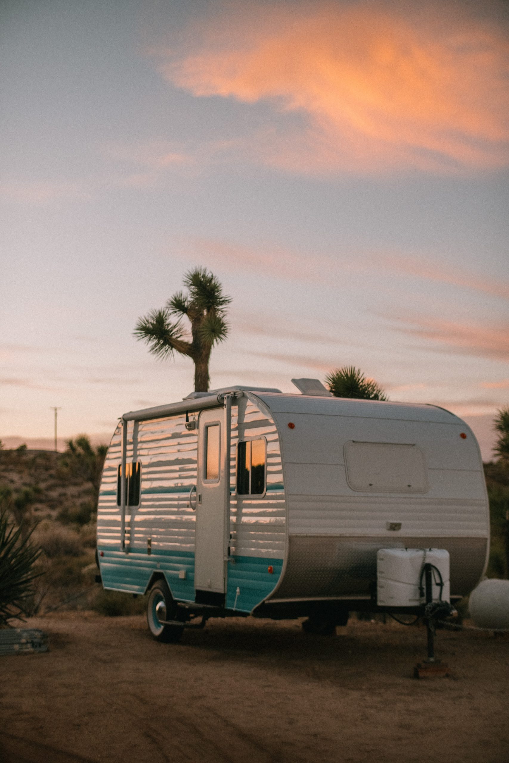 White and blue caravan in the sunset