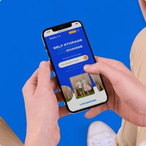 A person holding a phone with a blue background and a text message on it.