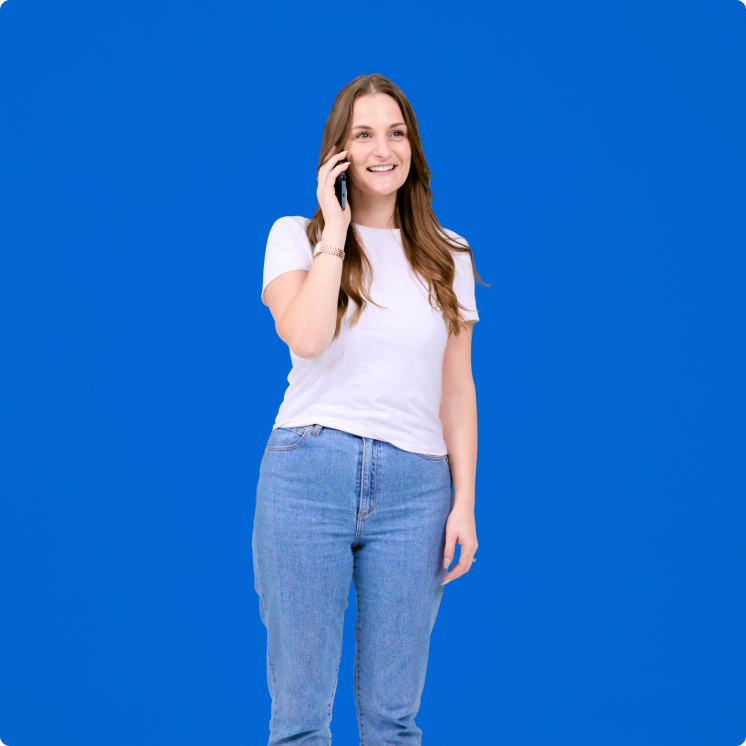 A woman talking on a cell phone against a blue background.